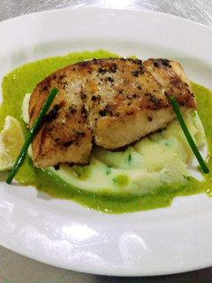A picture of Peppered Mbuta with garlic mashed potatoes and parsley sauce.