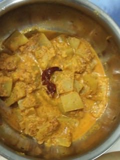 A picture of Lauki curry with mustard seeds and poppy seeds paste.