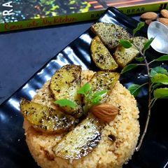 A picture of Daliya couscous with curry leaf pesto crusted potatoes.