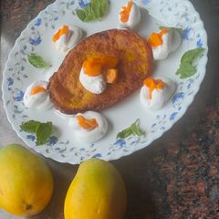 A picture of Mango malpua with fresh cream.