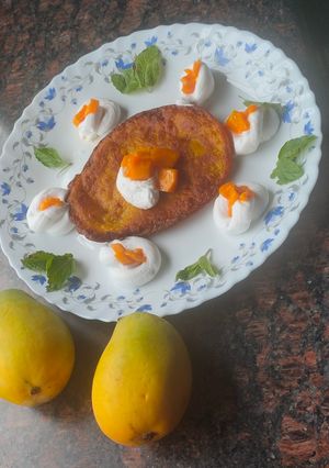 A picture of Mango malpua with fresh cream.
