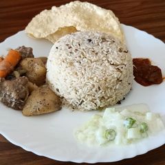 A picture of Ghee rice and chicken stew.