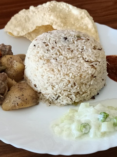 A picture of Ghee rice and chicken stew.