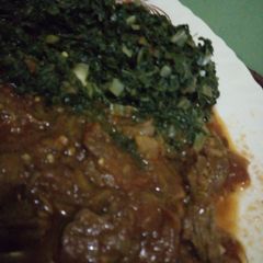 A picture of Beef stew with sukuma wiki.
