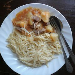 A picture of Spaghetti and  beef stew with potatoes.