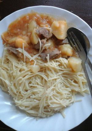 A picture of Spaghetti and  beef stew with potatoes.