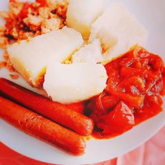 A picture of Boiled yam,pepper sauce and sausages.