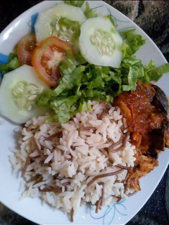 A picture of Rice and brown spaghetti with stew.