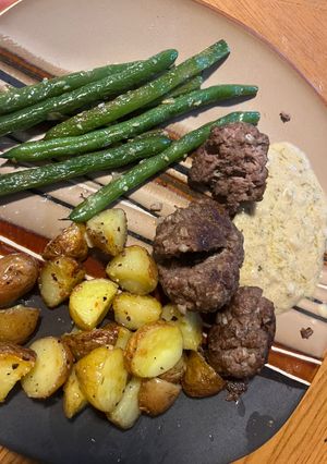 A picture of Meatloaf balls with creamy thyme sauce.