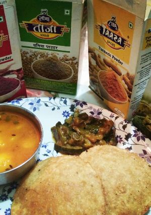 A picture of Poori aalu & khatti meethi kaddu sabzi.