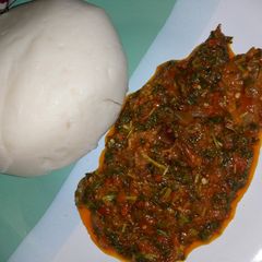 A picture of Pounded yam and vegetable soup.