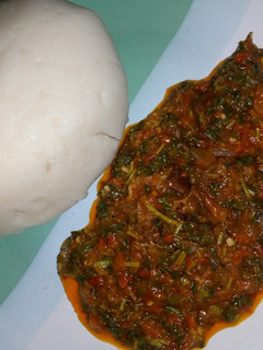A picture of Pounded yam and vegetable soup.
