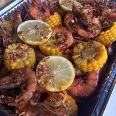 A picture of Spicy lemon butter garlic shrimp with corn.