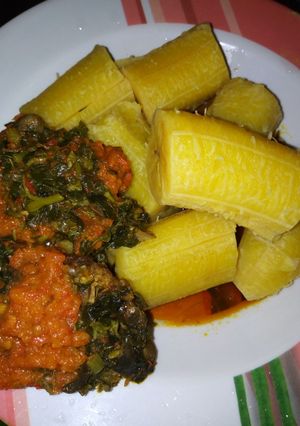 A picture of Ripe boiled plantain and vegetables with stew.