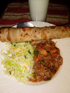 A picture of Chapati served with beef and steamed cabbage.