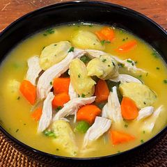 A picture of Chicken soup with dumplings.