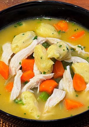 A picture of Chicken soup with dumplings.