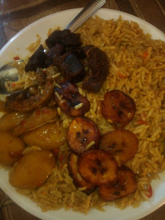A picture of Jallof rice with plaintains and Irish.