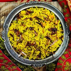 A picture of Quick Vegetable biryani with winter vegetables in cooker.