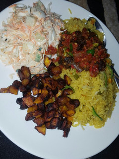 A picture of Fried rice with sauce and coslow.