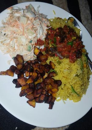 A picture of Fried rice with sauce and coslow.