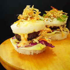 A picture of Japanise Sushi Burger with Mutton Kebab and Kimchi Salad.