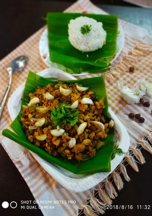 A picture of Fried garlic raw banana poriyal with rice.