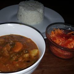 A picture of Beef curry with red and green peppers.