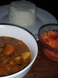 A picture of Beef curry with red and green peppers.