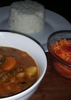 A picture of Beef curry with red and green peppers.