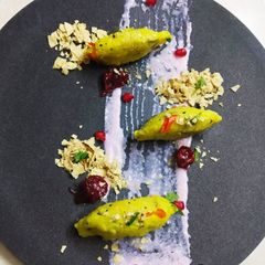 A picture of Vegetable khichdi with pomegranate raita.