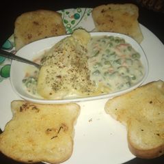 Potato baked dish with garlic bread A picture of Potato baked dish with garlic bread.
