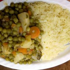 A picture of Tumeric Rice with peas stew.