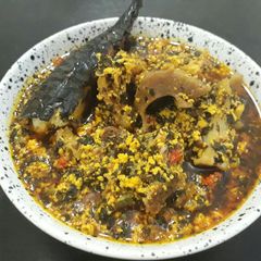 A picture of Egusi with bitterleaf soup.