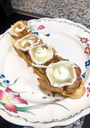 A picture of Iberian Pork Tenderloin Toast with Caramelized Onion and Goat Cheese Log.