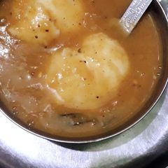 A picture of Idli with sambhar.
