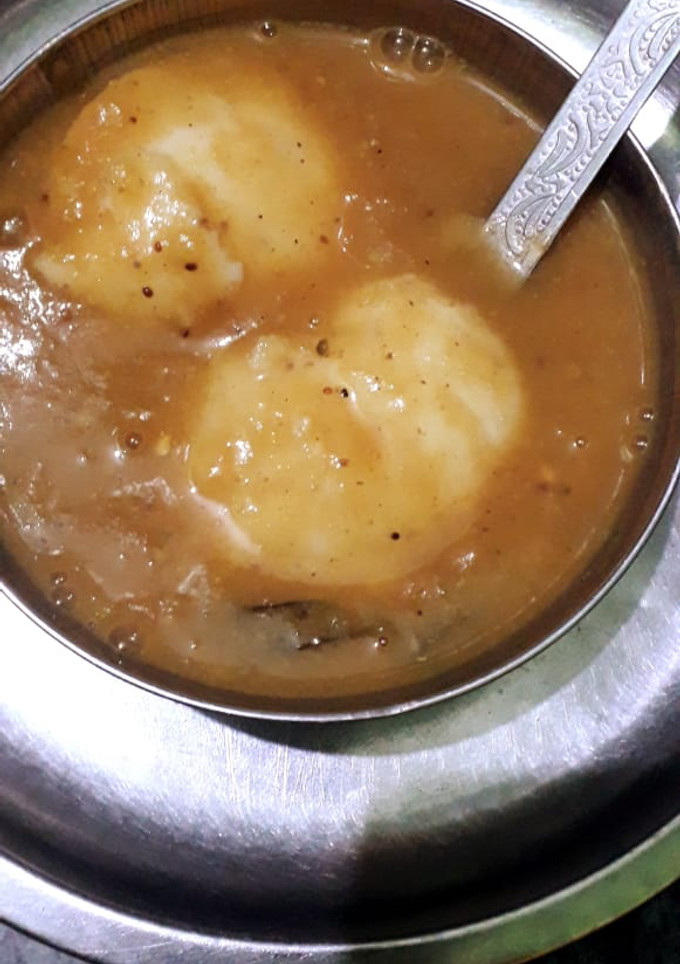 A picture of Idli with sambhar.