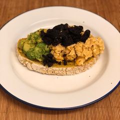 A picture of Paprika eggs. Turmeric Sourdough. Black pudding crumb. Smashed avocado.
