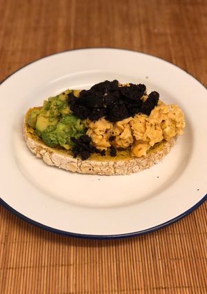 A picture of Paprika eggs. Turmeric Sourdough. Black pudding crumb. Smashed avocado.