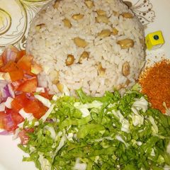 A picture of Rice and beans with salad.