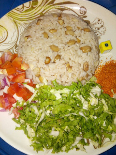 A picture of Rice and beans with salad.