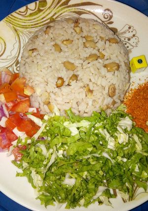 A picture of Rice and beans with salad.