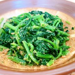 A picture of Cooked spinach seasoned with sweet sesame sauce.