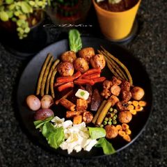 A picture of Grilled vegetables and soybean with sauce.