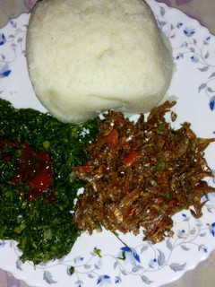 A picture of Fried sardines(omena), skuma wiki and Ugali.