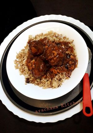 A picture of Veg manchurian with fried rice.