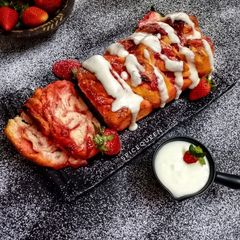 A picture of Strawberry Babka Bread with Cream Cheese Frosting.