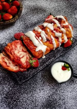 A picture of Strawberry Babka Bread with Cream Cheese Frosting.