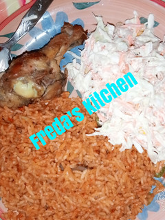 A picture of Jollof rice with salad.