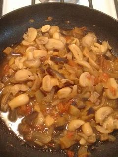 Una foto de Berenjena con tomate y champiñones.ॐ